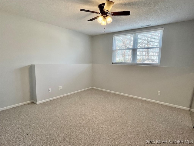 unfurnished room with ceiling fan, carpet floors, and a textured ceiling