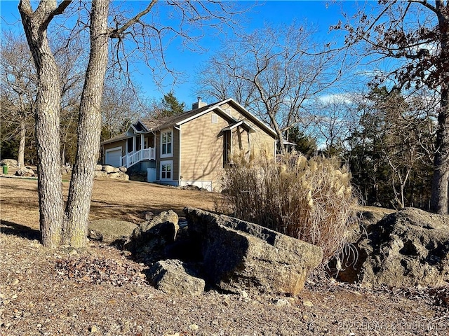 view of side of home featuring a garage