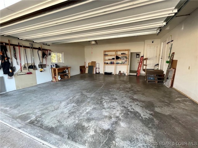 garage with a garage door opener and a workshop area