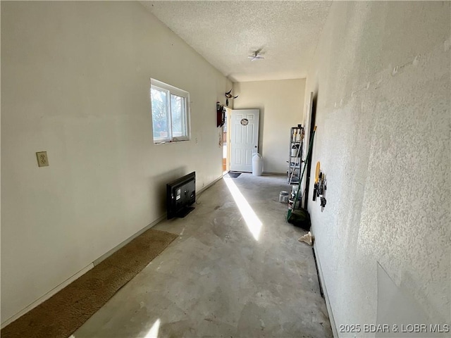 hall with a textured ceiling