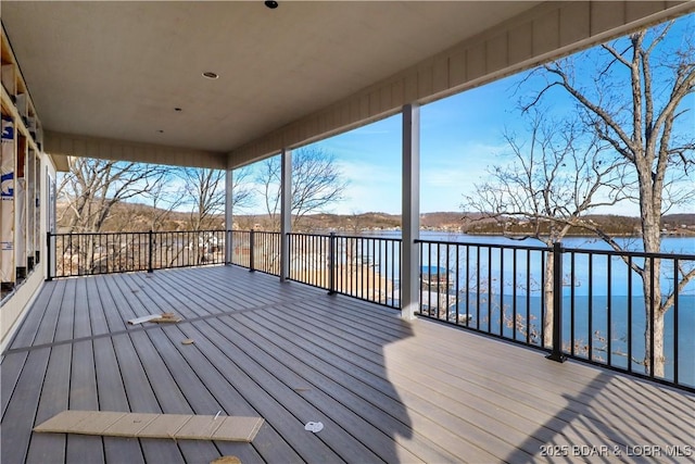 wooden terrace featuring a water view