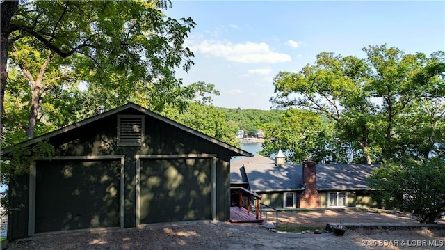 view of front of property with a garage and an outdoor structure