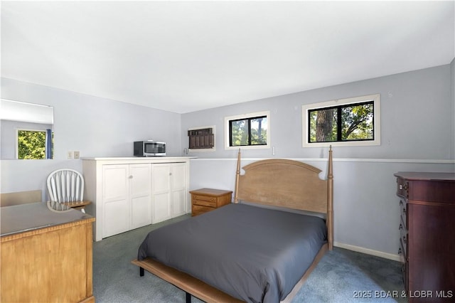 carpeted bedroom featuring multiple windows