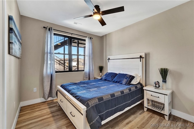 bedroom with hardwood / wood-style floors and ceiling fan