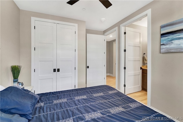 bedroom with hardwood / wood-style flooring, ceiling fan, and a closet