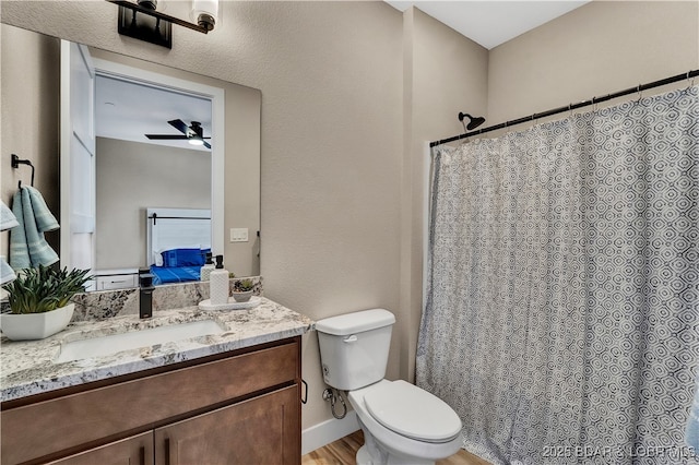 bathroom with vanity, ceiling fan, wood-type flooring, and toilet