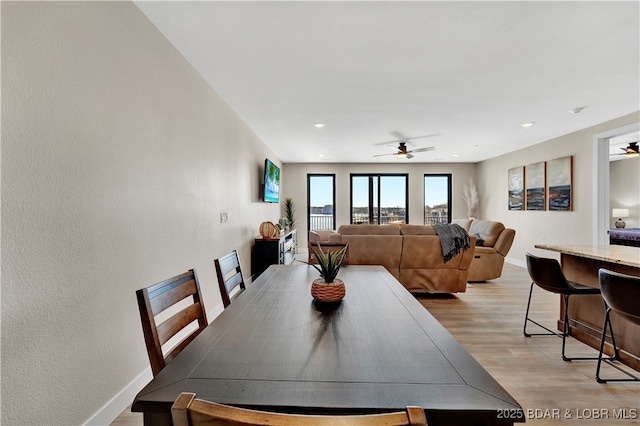 dining space featuring ceiling fan and light hardwood / wood-style floors