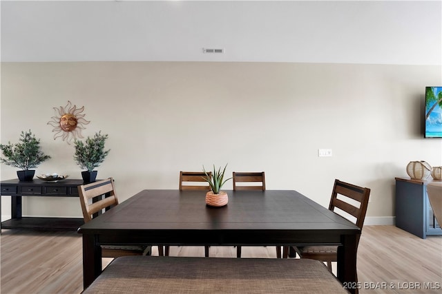 dining space featuring light wood-type flooring