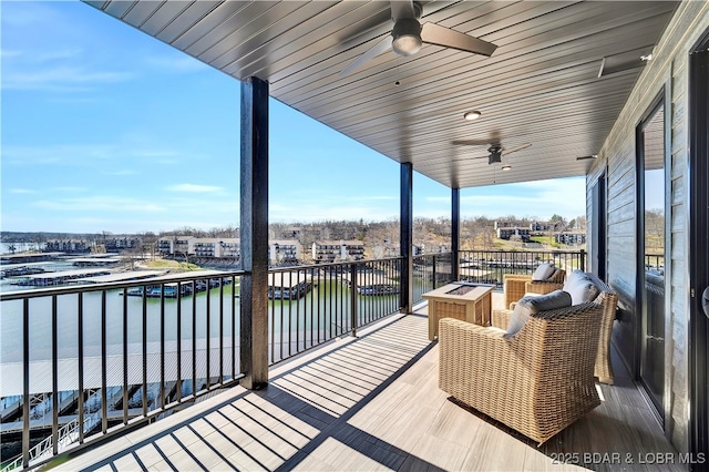 deck featuring a water view and ceiling fan