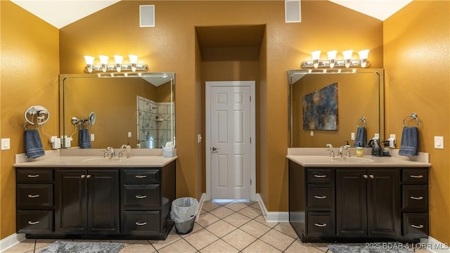 bathroom with vanity, lofted ceiling, and tile patterned floors