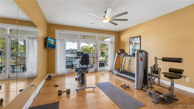 workout area featuring ceiling fan and light wood-type flooring