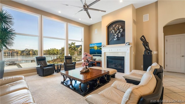 tiled living room featuring a towering ceiling and ceiling fan