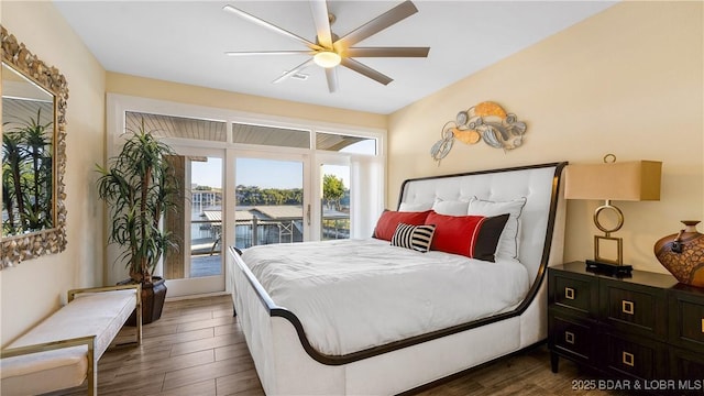 bedroom featuring access to outside, dark hardwood / wood-style floors, and ceiling fan