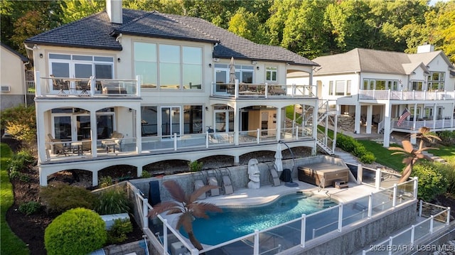 back of property featuring a patio and a balcony