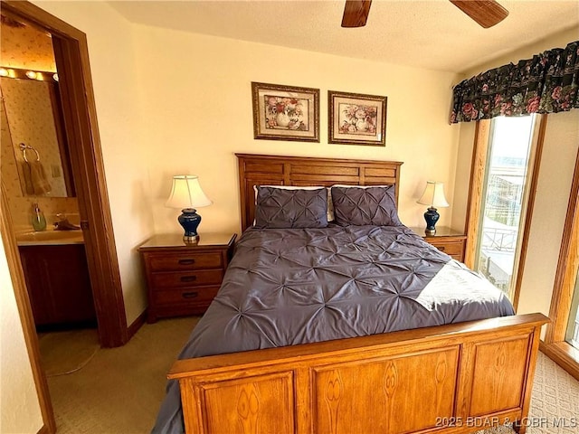 carpeted bedroom with connected bathroom, sink, a textured ceiling, access to outside, and ceiling fan