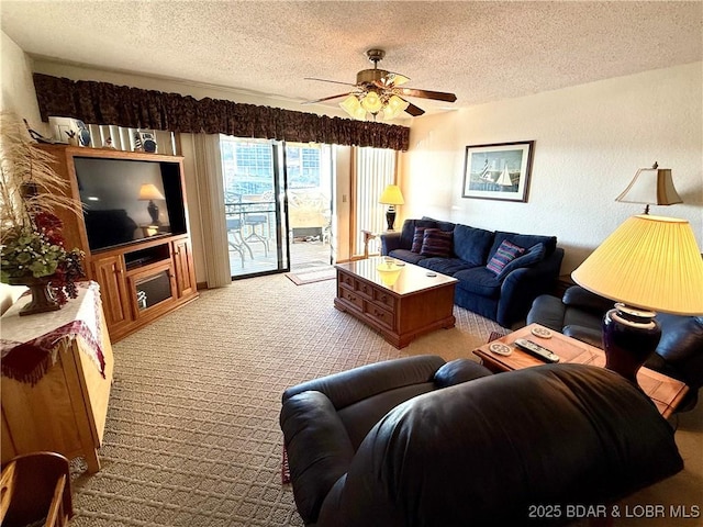 living room with ceiling fan, light colored carpet, and a textured ceiling