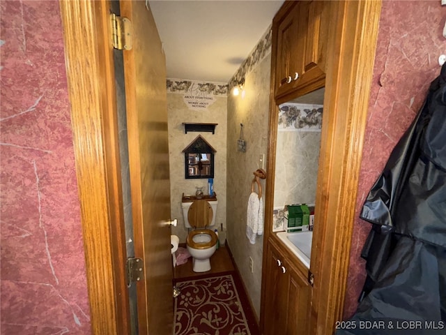 bathroom featuring a tub to relax in and toilet