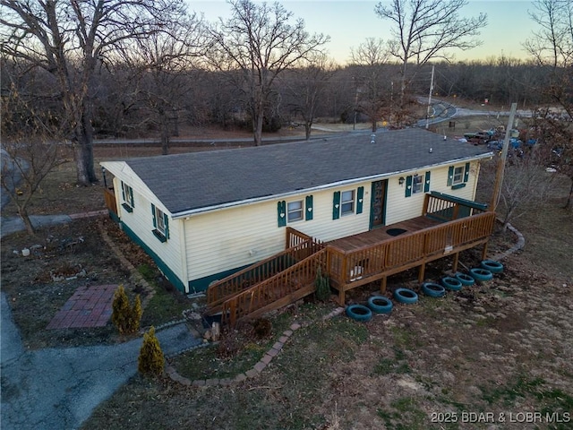 view of front of house with a deck and central AC unit