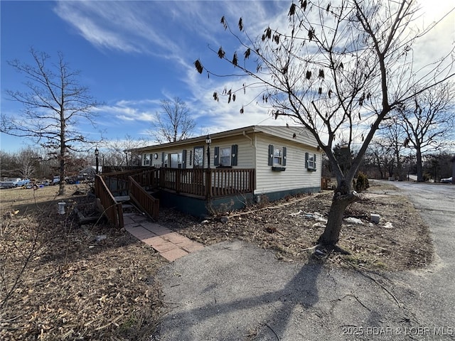 view of side of property with a wooden deck