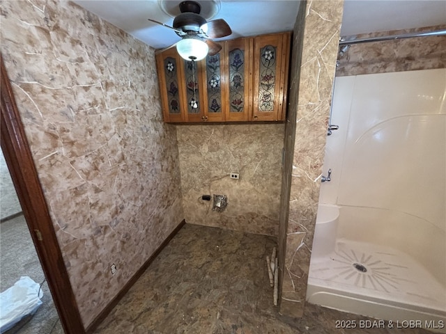 bathroom with ceiling fan and tiled shower