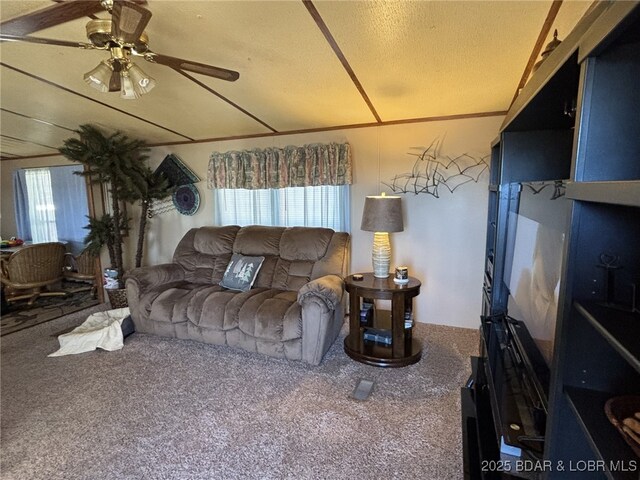 living room with ceiling fan and carpet