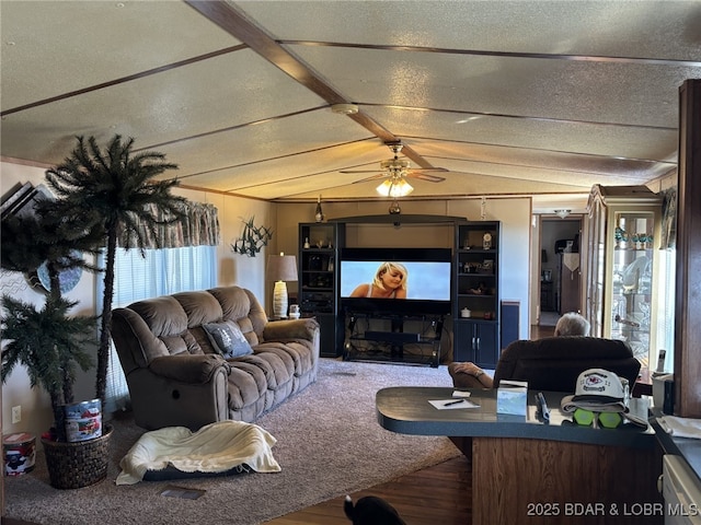 living room featuring ceiling fan, wood-type flooring, lofted ceiling with beams, and a textured ceiling