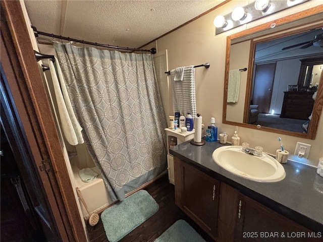 bathroom featuring shower / bath combo, crown molding, vanity, and a textured ceiling