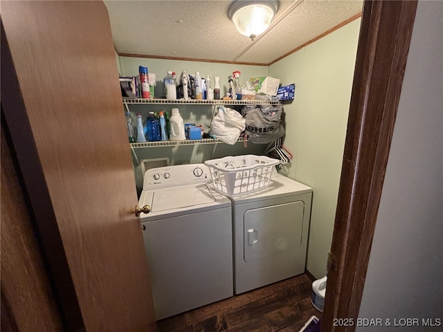 washroom featuring separate washer and dryer, ornamental molding, dark hardwood / wood-style floors, and a textured ceiling