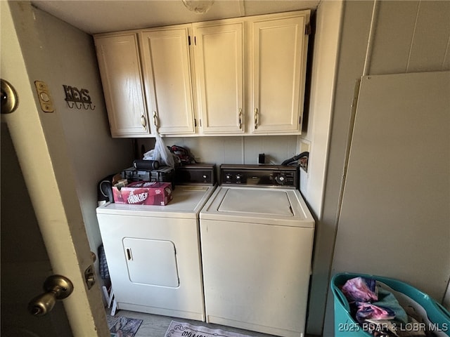 washroom with washing machine and dryer and cabinets