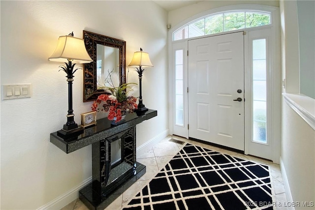 foyer featuring light tile patterned floors