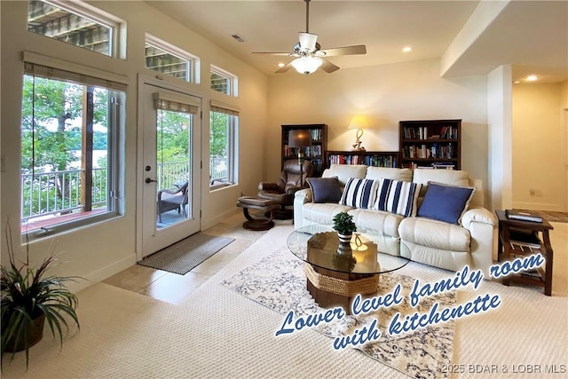 tiled living room featuring plenty of natural light and ceiling fan