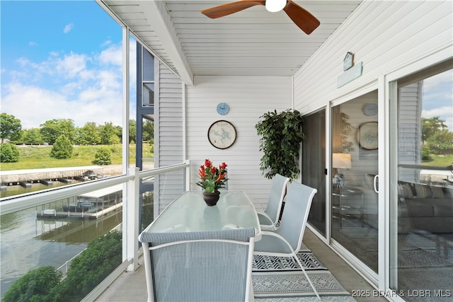 sunroom / solarium featuring ceiling fan