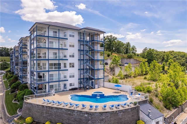 view of property with pool water feature and a community pool