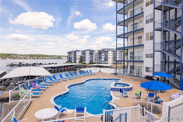 view of swimming pool featuring a patio and a community hot tub