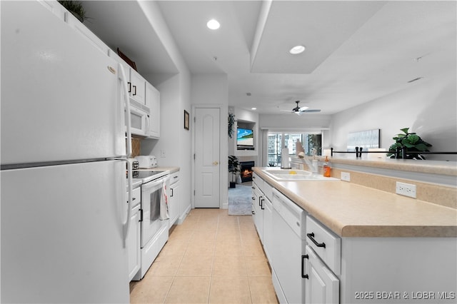 kitchen featuring sink, white appliances, ceiling fan, white cabinetry, and light tile patterned flooring