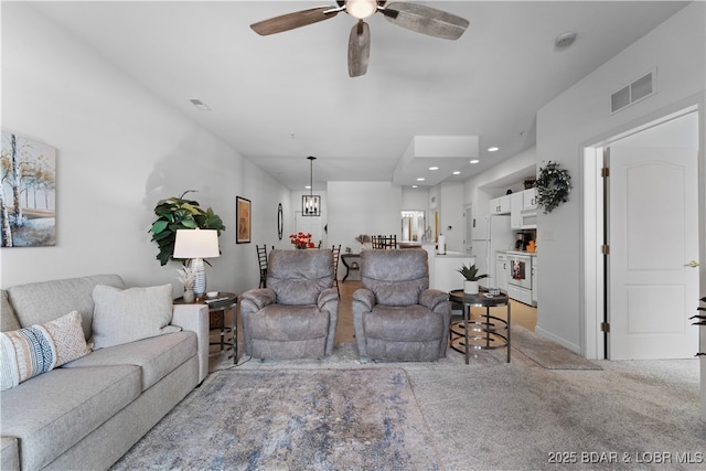 living room with light carpet and ceiling fan