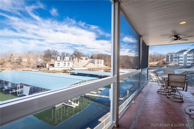 exterior space with ceiling fan and a water view