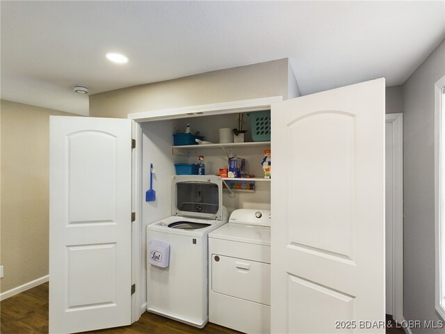 laundry room featuring washer and clothes dryer and dark hardwood / wood-style floors