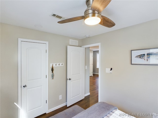 bedroom with ceiling fan and dark hardwood / wood-style flooring