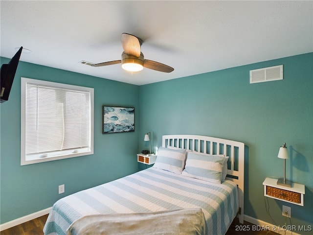 bedroom with ceiling fan and dark hardwood / wood-style flooring