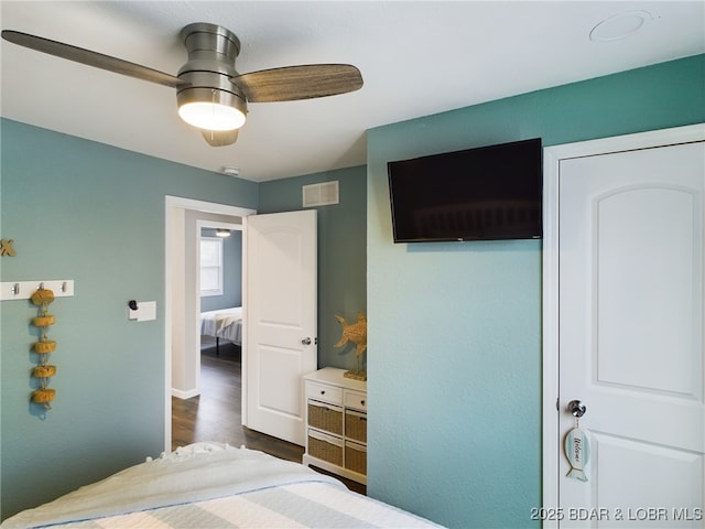 bedroom featuring dark wood-type flooring and ceiling fan