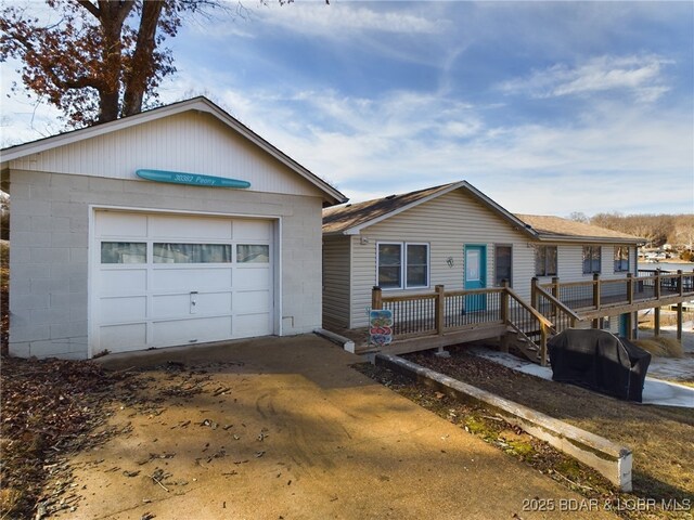 view of front of house with a garage and a wooden deck