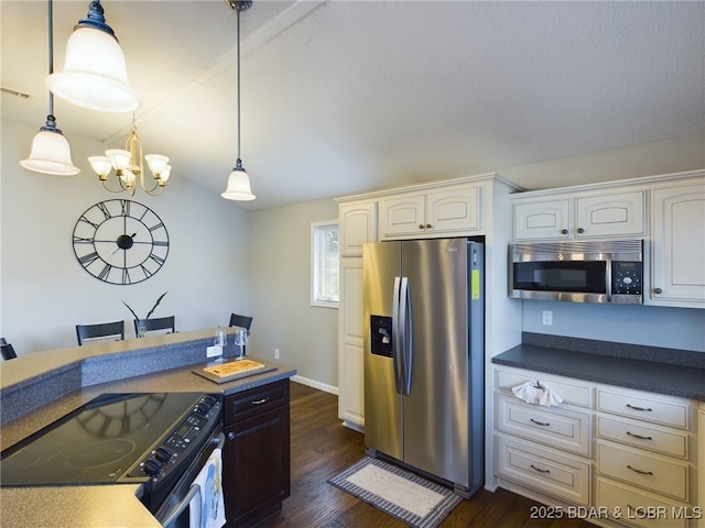 kitchen with white cabinetry, appliances with stainless steel finishes, dark hardwood / wood-style flooring, and decorative light fixtures