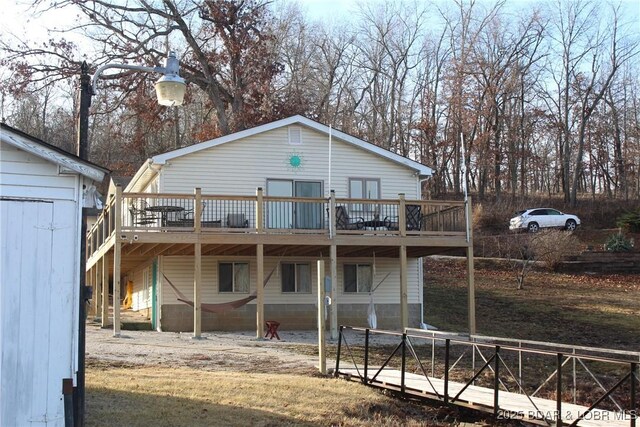 rear view of property with a wooden deck