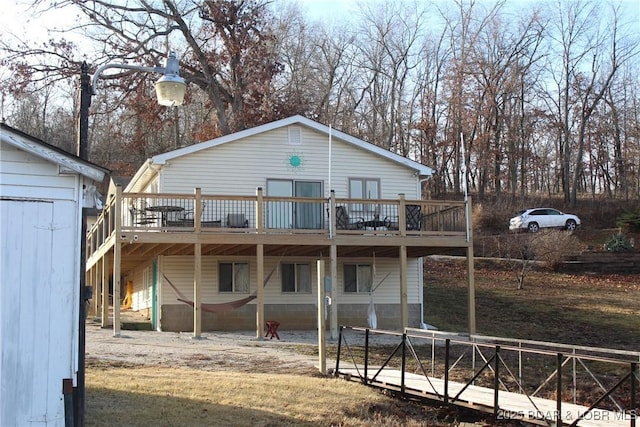 back of house featuring a wooden deck