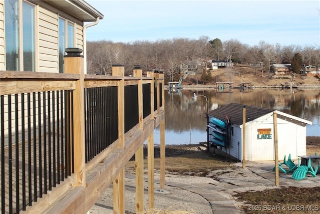 exterior space featuring a shed and a water view