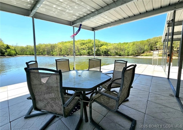 view of patio featuring a water view and a dock