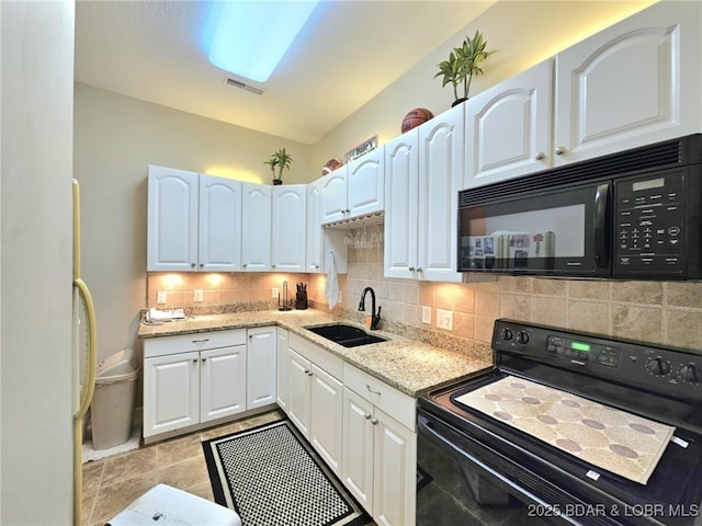 kitchen featuring tasteful backsplash, white cabinetry, sink, and black appliances