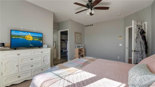 bedroom featuring a spacious closet and ceiling fan