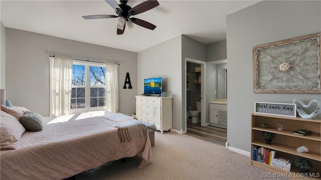 carpeted bedroom with ceiling fan and ensuite bath